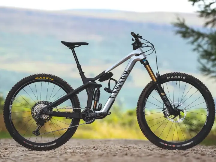 A silver Canyon enduro mountain bike with full suspension, ready to tackle any trail.